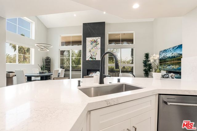 a view living room with granite countertop a couch and large window