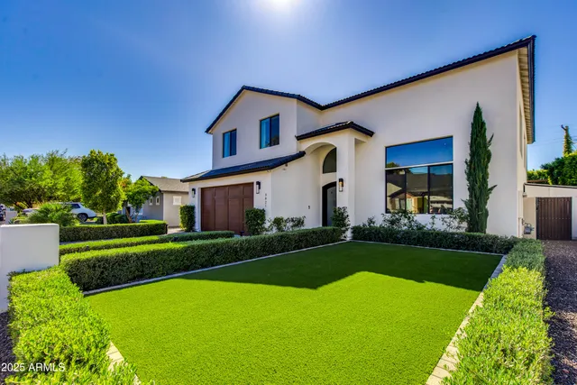 a front view of house with yard and green space