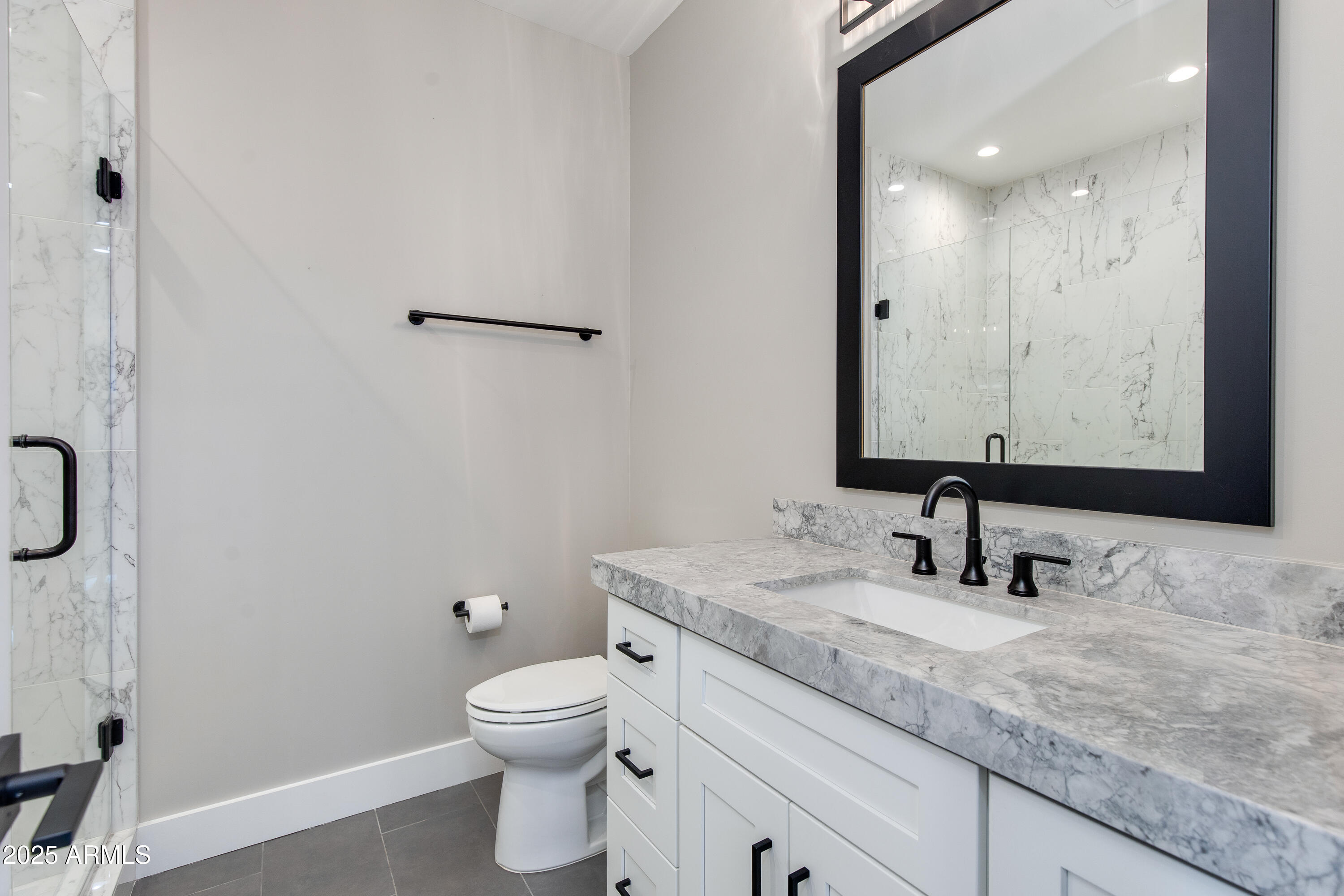 3821 East Devonshire Avenue Phoenix, AZ 85018 - Photo 12 of 20 a bathroom with a granite countertop toilet sink and mirror