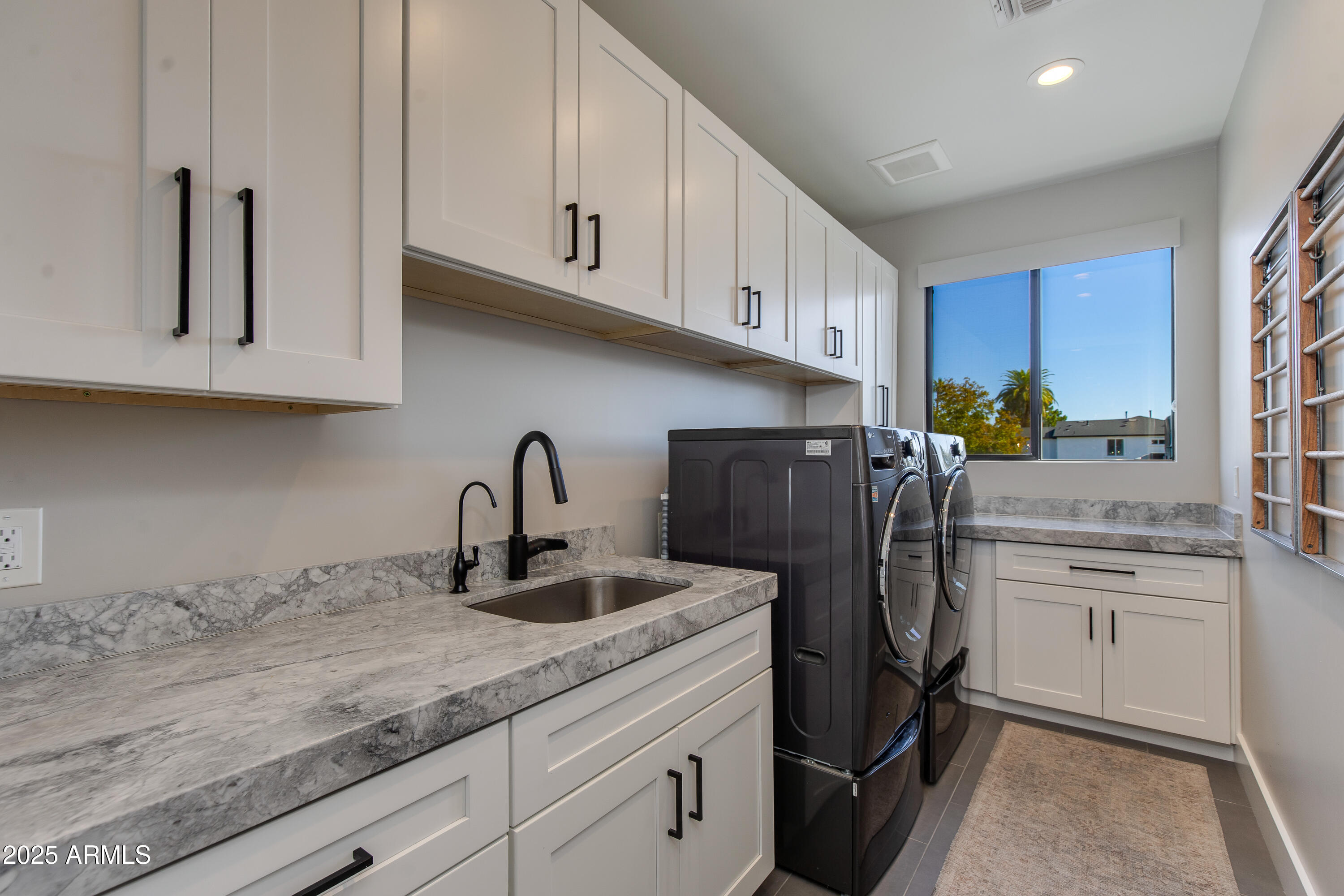 3821 East Devonshire Avenue Phoenix, AZ 85018 - Photo 14 of 20 a kitchen with stainless steel appliances granite countertop a refrigerator sink and cabinets