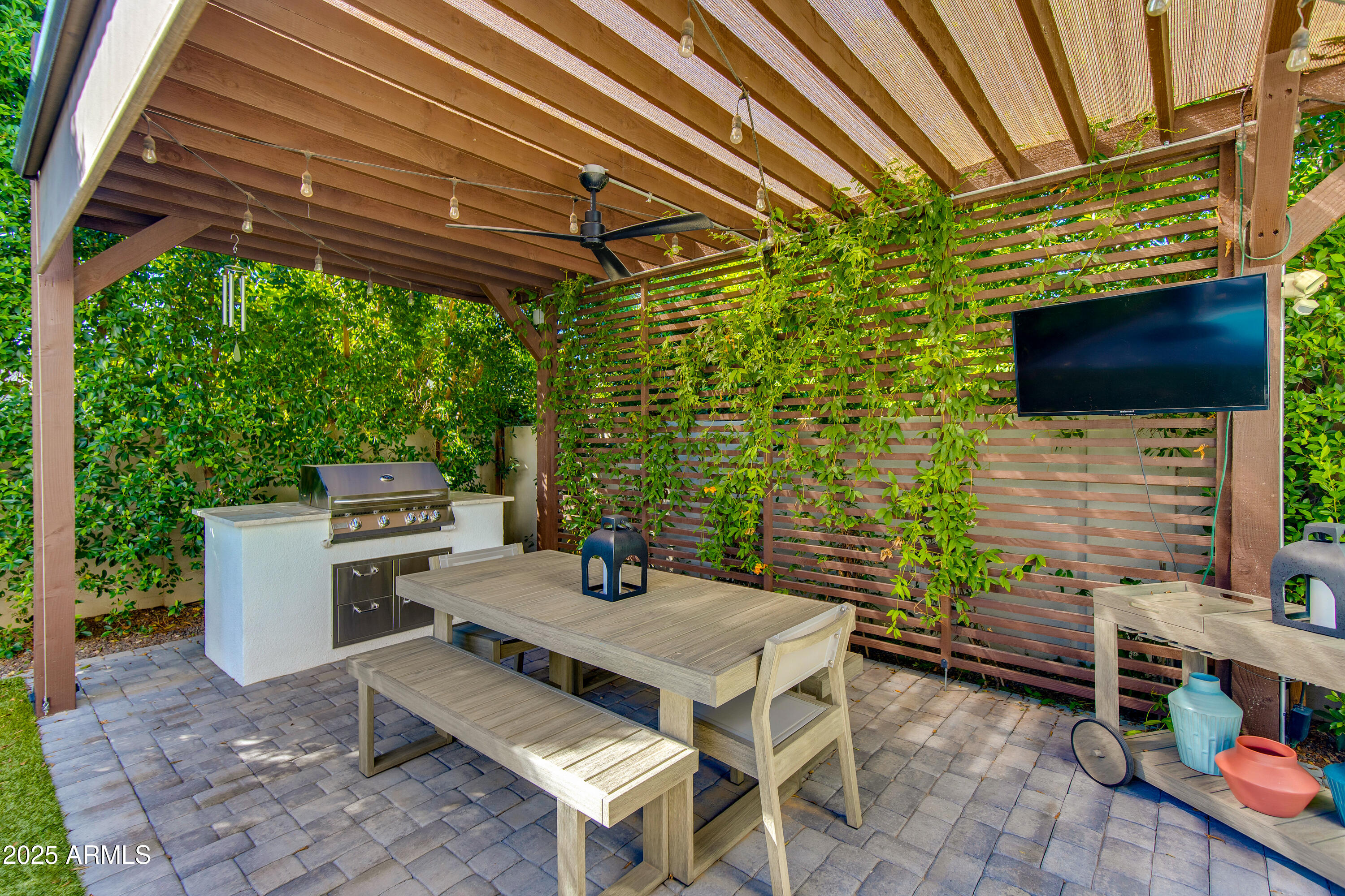 3821 East Devonshire Avenue Phoenix, AZ 85018 - Photo 16 of 20 a backyard of a house with barbeque oven table and chairs
