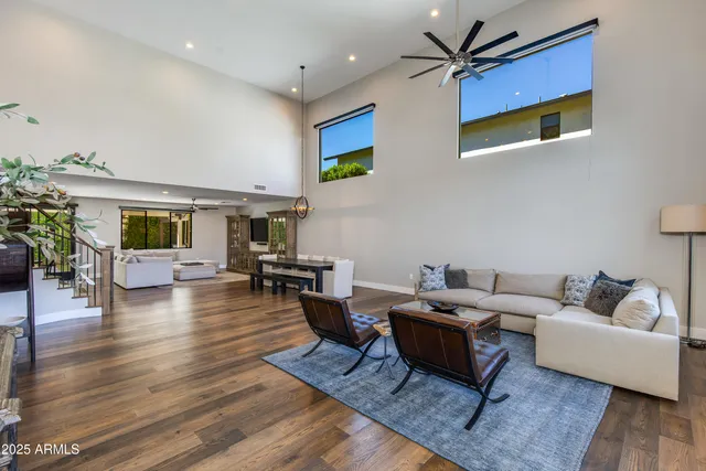 a living room with furniture and a wooden floor