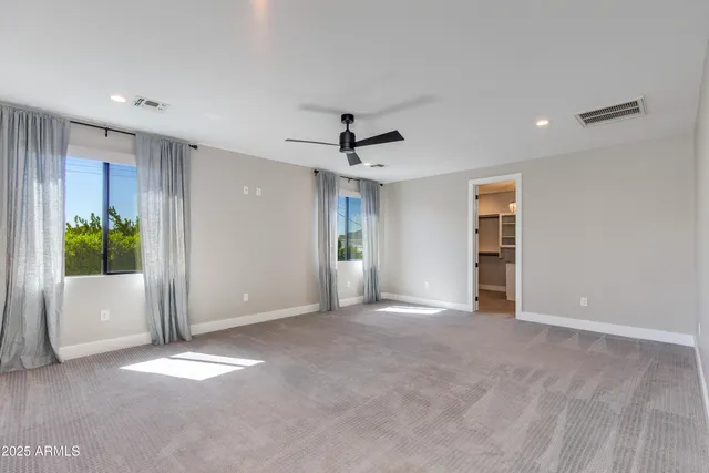 an empty room with windows and closet