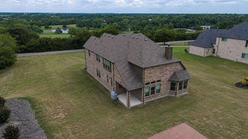 25 Morrison Road Howe, TX 75459 - Photo 26 of 27 Brick exterior with a multi-gabled roofline and an integrated covered patio