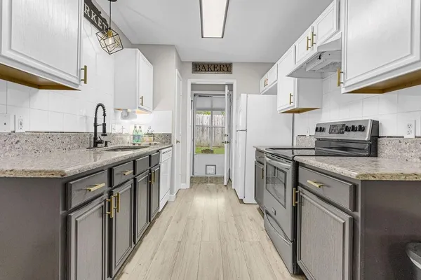 a kitchen with stainless steel appliances granite countertop a stove and a sink