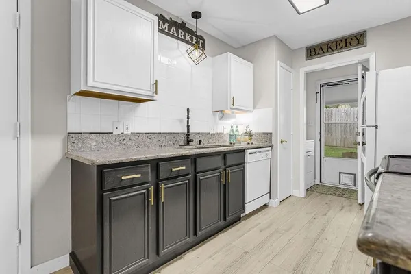 a kitchen with stainless steel appliances granite countertop a sink stove and cabinets