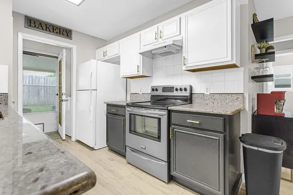 a kitchen with stainless steel appliances granite countertop a refrigerator stove and sink