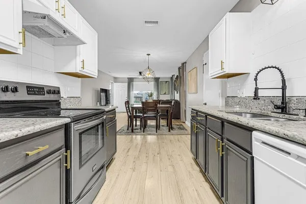 a kitchen with stainless steel appliances granite countertop a stove and a sink