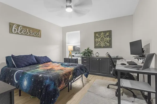 a bedroom with a bed and a desk