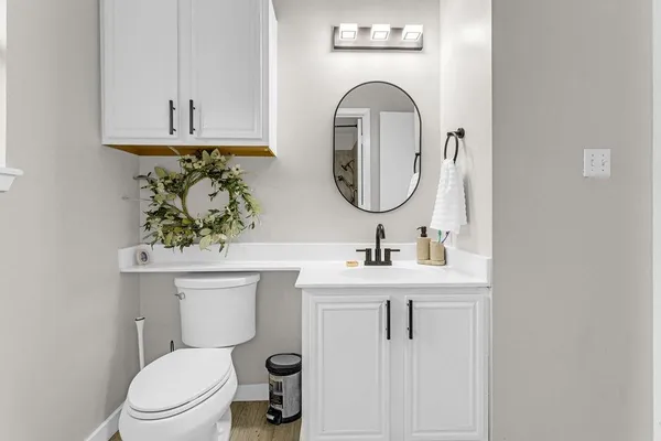 a bathroom with a toilet sink and mirror