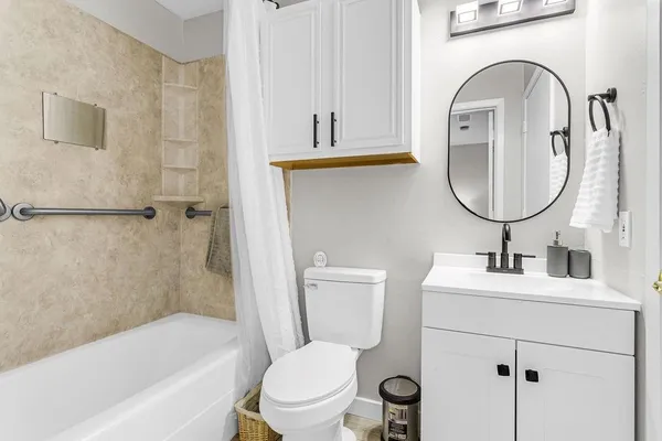 a bathroom with a sink a toilet and a mirror