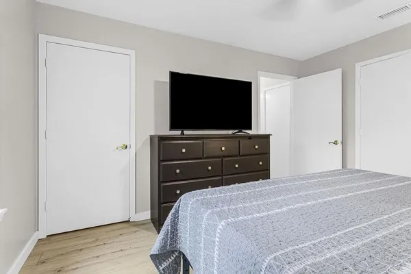 a bedroom with a bed and a flat screen tv