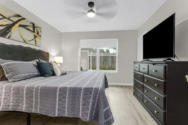 a bedroom with a bed and flat screen tv