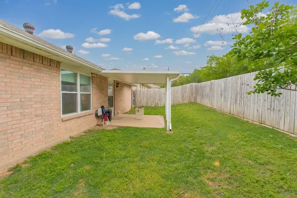 a view of backyard with a garden and deck