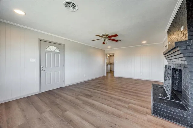 wooden floor in an empty room with a fireplace
