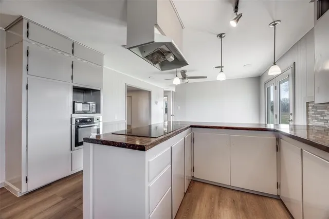 a kitchen with stainless steel appliances granite countertop a sink and a refrigerator