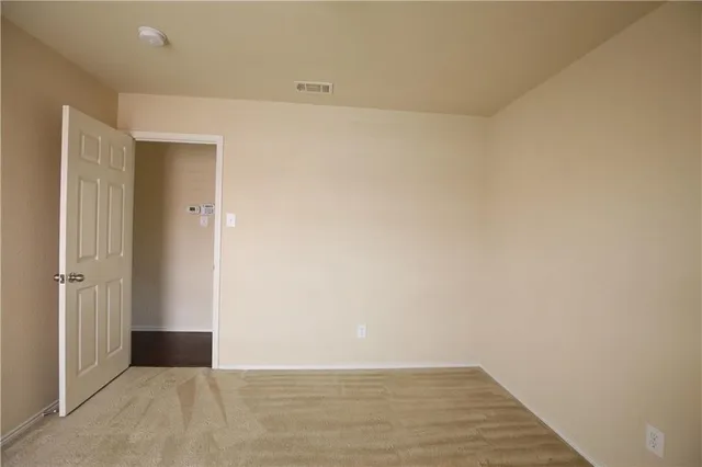 an empty room with wooden floor