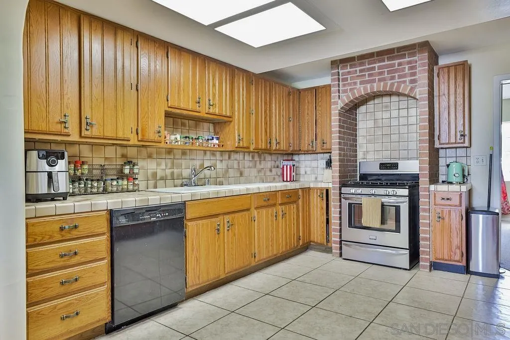 2260 Glenview Lane Vista, CA 92084 - Photo 23 of 24 a kitchen with granite countertop cabinets stainless steel appliances and a sink
