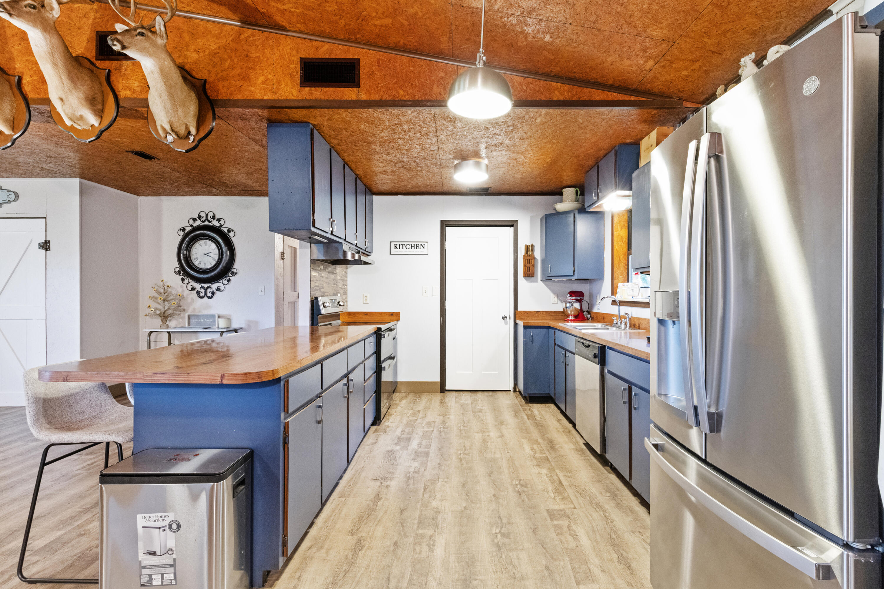 190 Peaden Bridge Road Baker, FL 32531 - Photo 16 of 73 a kitchen with stainless steel appliances granite countertop a refrigerator a sink dishwasher a stove and a dining table with wooden floor