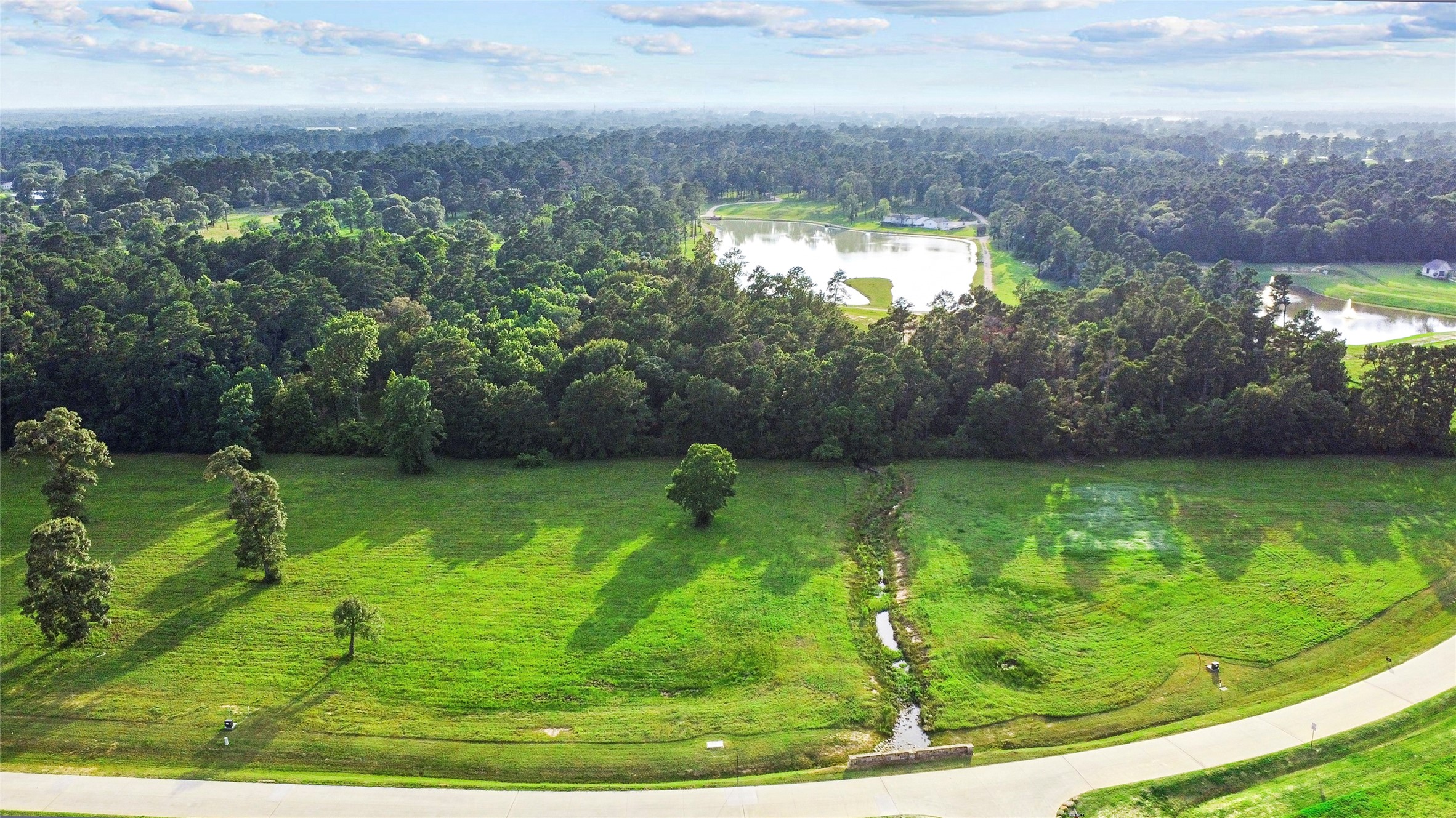 2044 Stallion Lakes Avenue Hockley, TX 77447 - Photo 4 of 17 A sweeping aerial view that shows how the homesite relates to the neighboring estates and community roads. The openness of the land is a major part of its appeal.