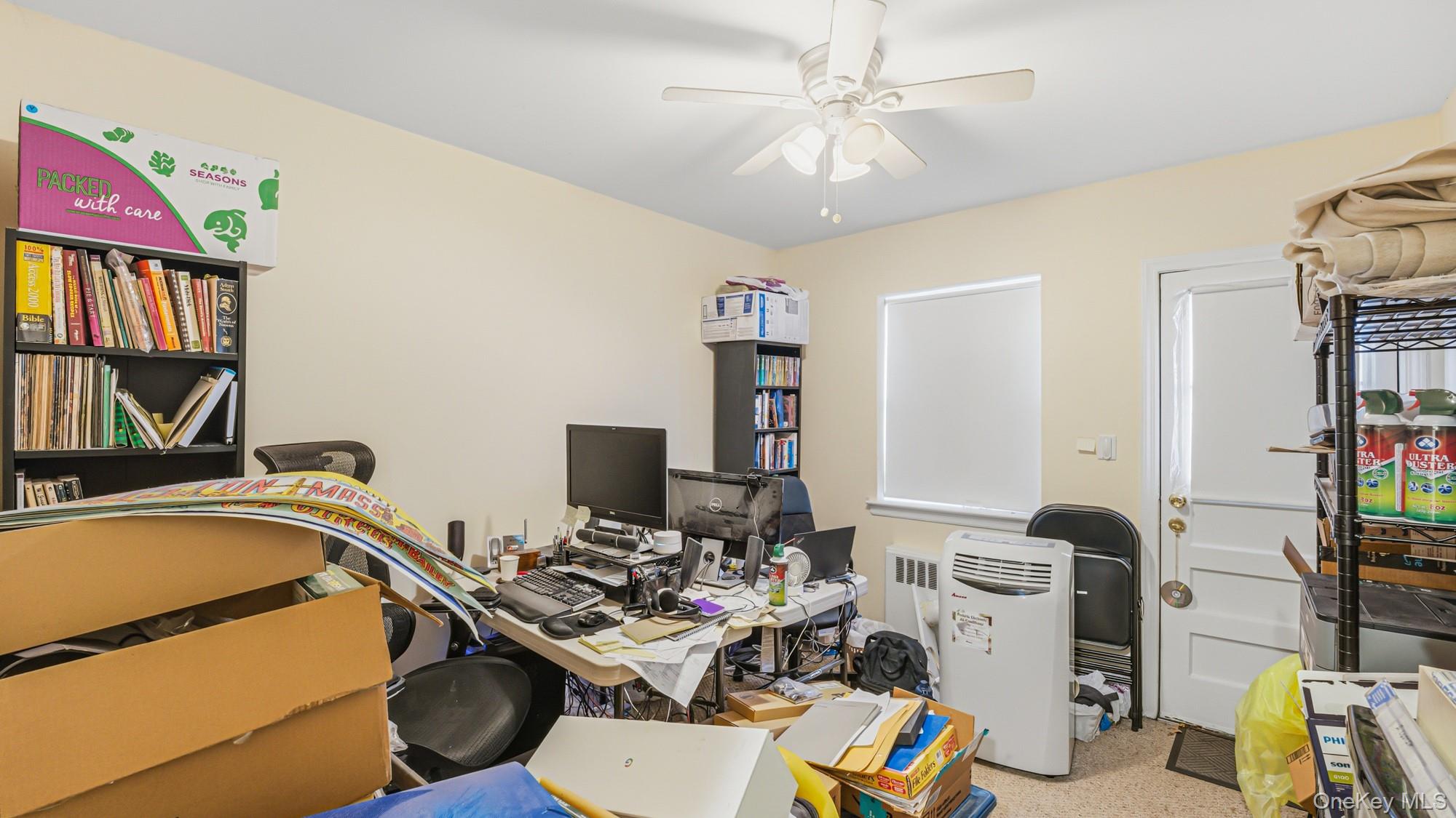 141-01 Jewel Avenue Queens, NY 11367 - Photo 11 of 21 a view of a workspace with furniture and a book shelf