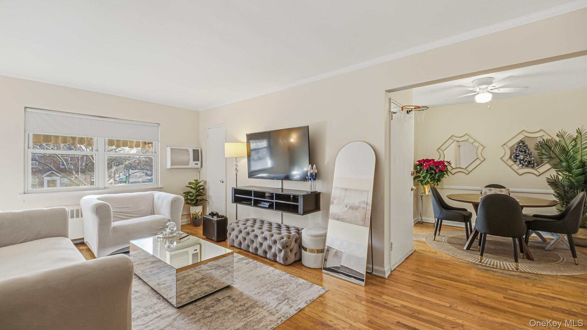 141-01 Jewel Avenue Queens, NY 11367 - Photo 13 of 21 a living room with furniture and a flat screen tv