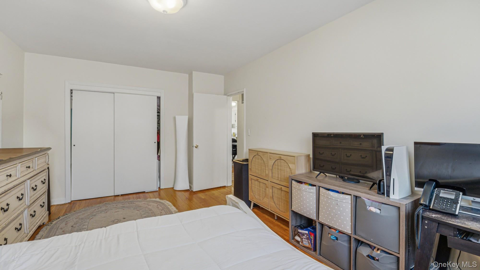 141-01 Jewel Avenue Queens, NY 11367 - Photo 14 of 21 a bedroom with a bed and flat screen tv