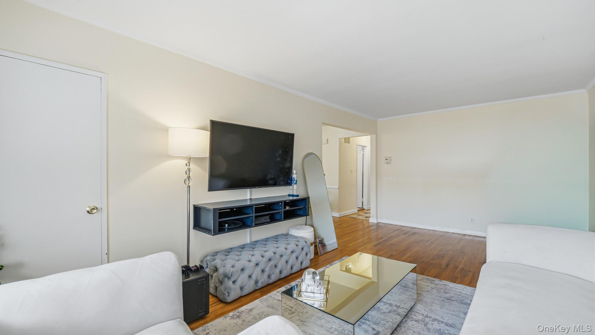 141-01 Jewel Avenue Queens, NY 11367 - Photo 16 of 21 a living room with furniture and a flat screen tv