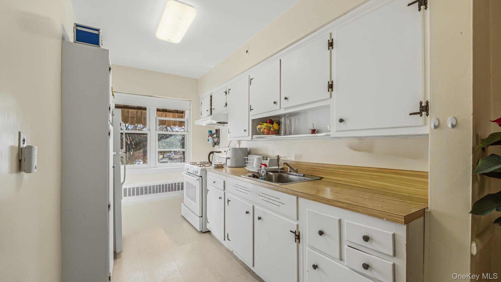 141-01 Jewel Avenue Queens, NY 11367 - Photo 17 of 21 a kitchen with granite countertop a sink and cabinets