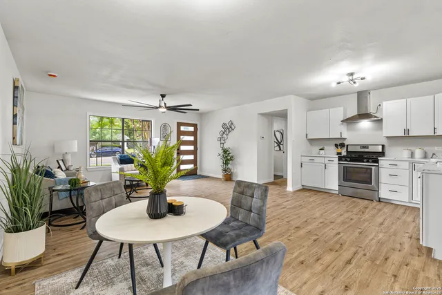 a kitchen with sink table and chairs
