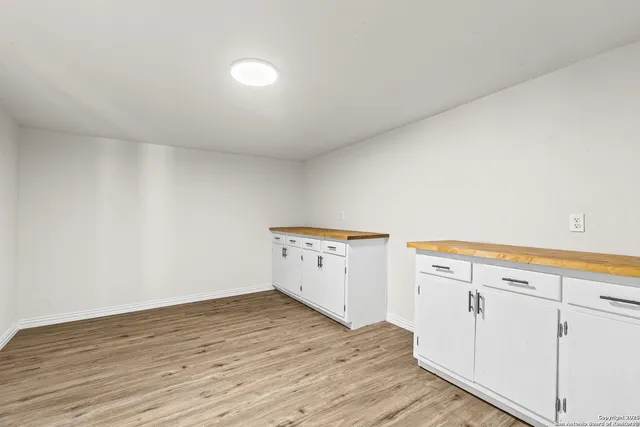a view of a kitchen with wooden floor