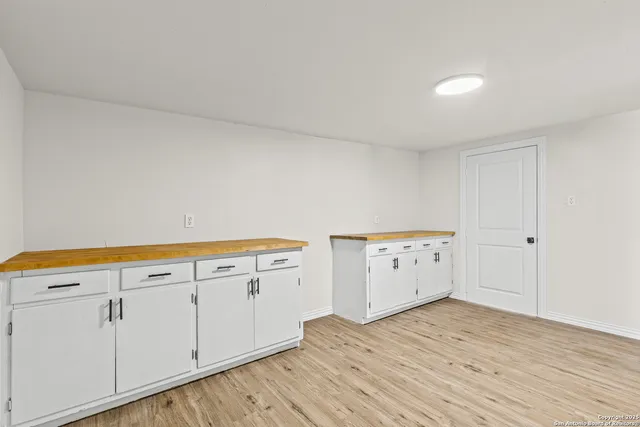 a view of a kitchen with wooden floor