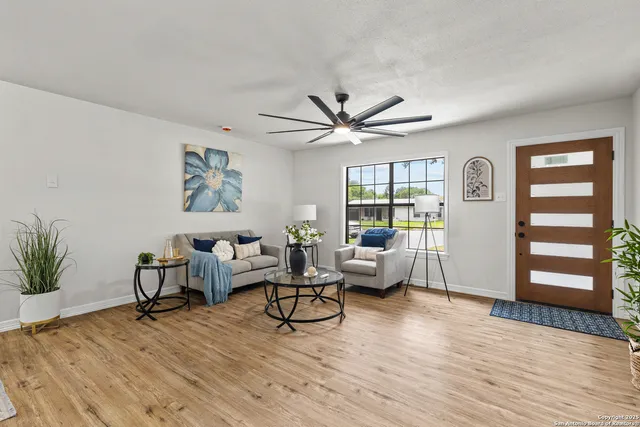 a living room with furniture and wooden floor