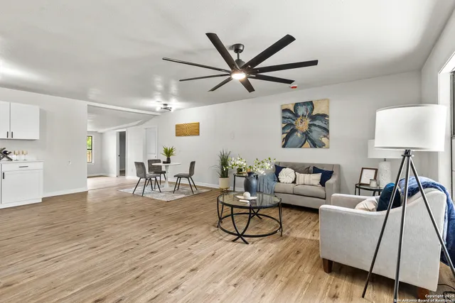 a living room with furniture and a wooden floor