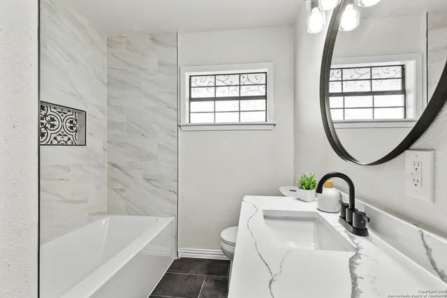 a bathroom with a sink a toilet and a bathtub