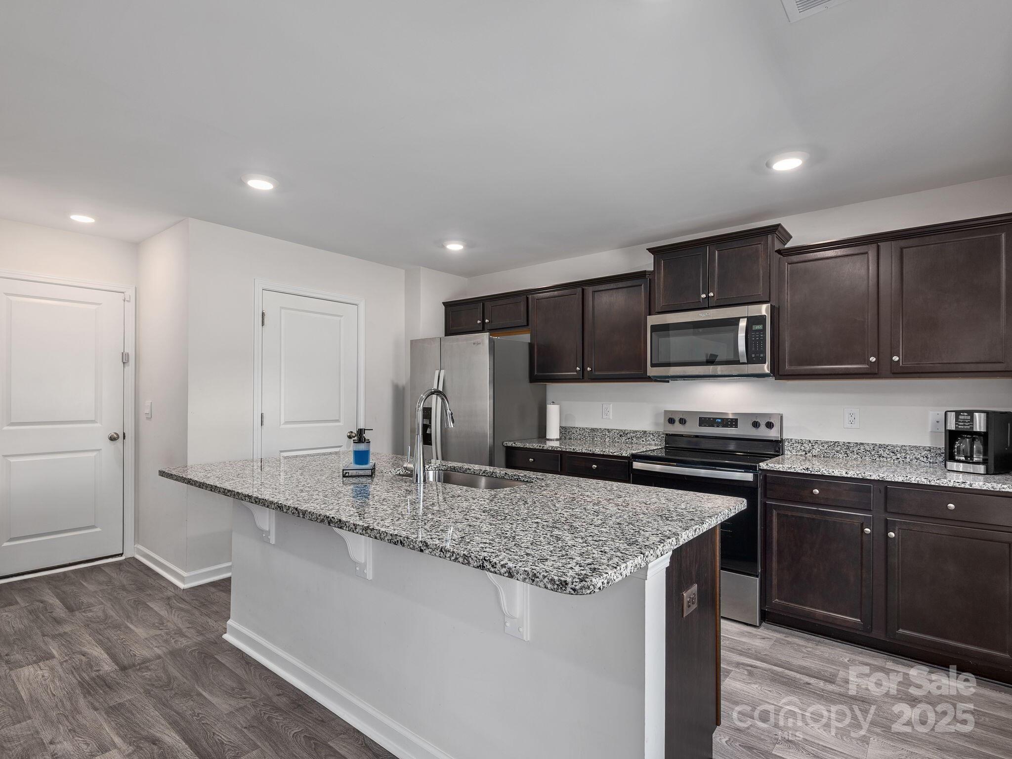 8 Madelyn Drive Clyde, NC 28721 - Photo 12 of 34 a kitchen with stainless steel appliances granite countertop a sink a stove a refrigerator and cabinets