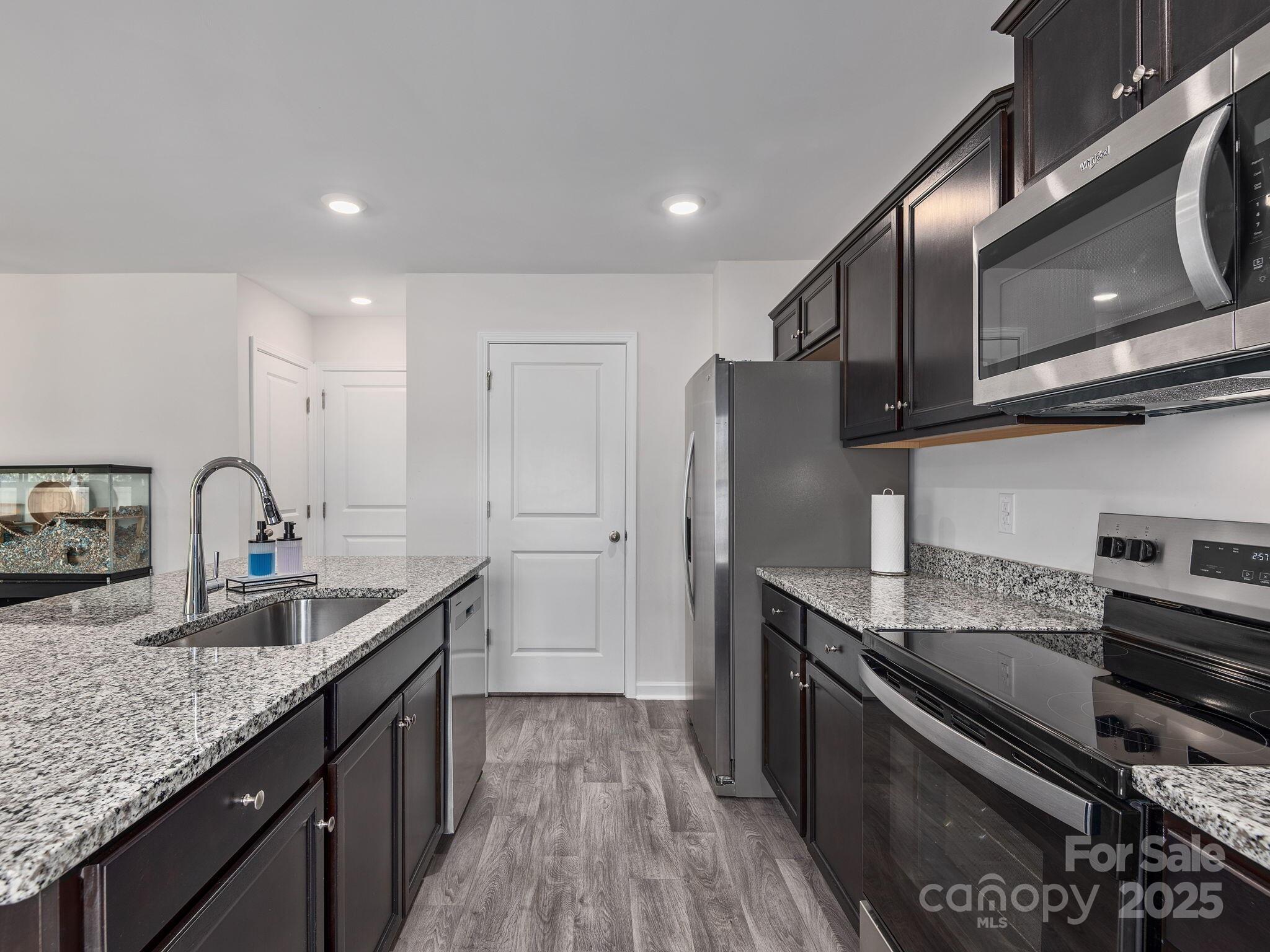 8 Madelyn Drive Clyde, NC 28721 - Photo 13 of 34 a kitchen with stainless steel appliances granite countertop a sink stove and refrigerator