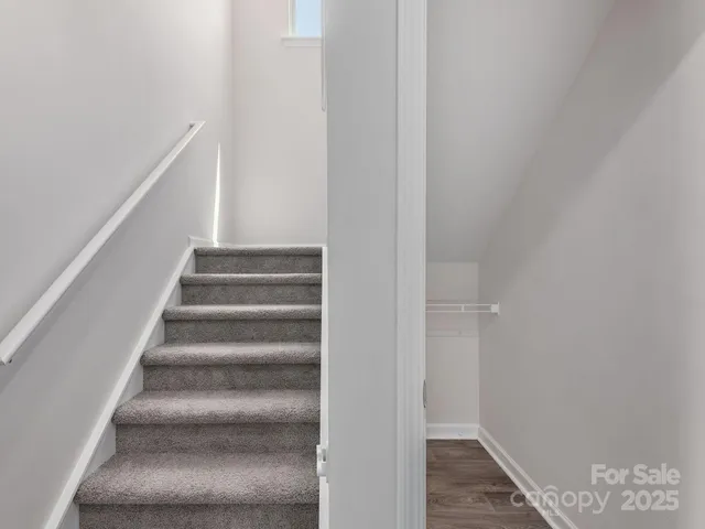 a view of staircase with white walls