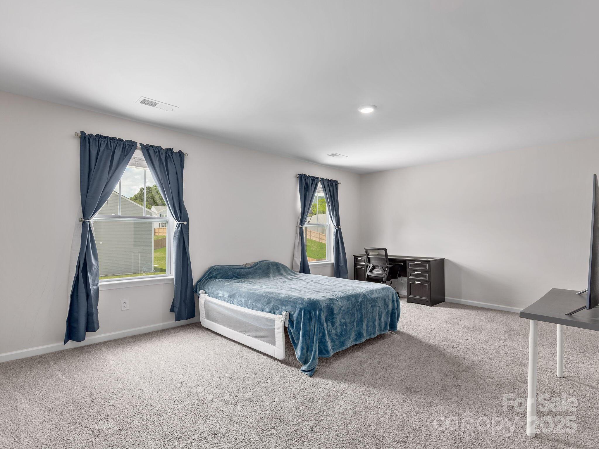 8 Madelyn Drive Clyde, NC 28721 - Photo 17 of 34 a spacious bedroom with a bed and window