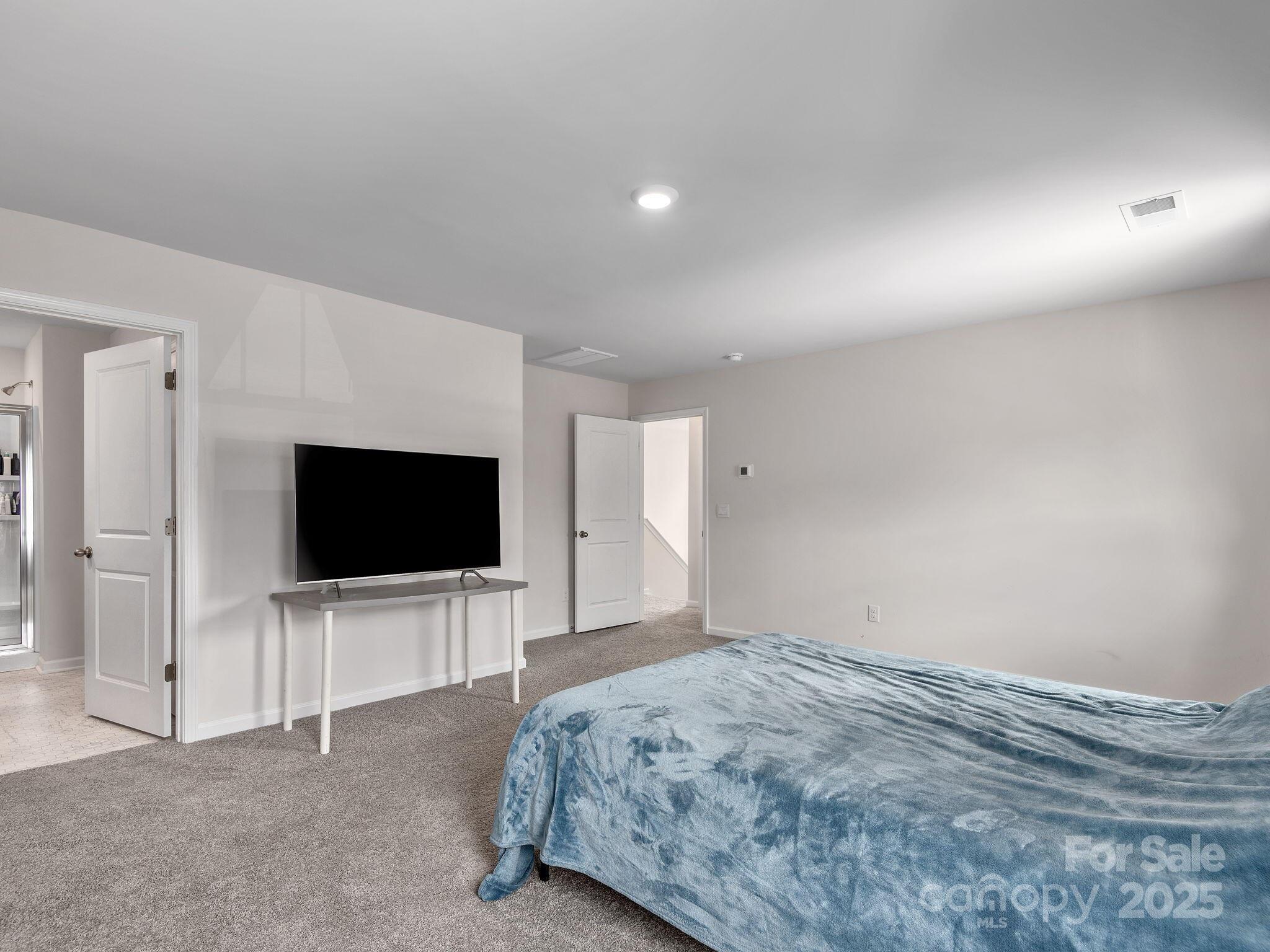 8 Madelyn Drive Clyde, NC 28721 - Photo 20 of 34 a bedroom with a bed and a flat screen tv