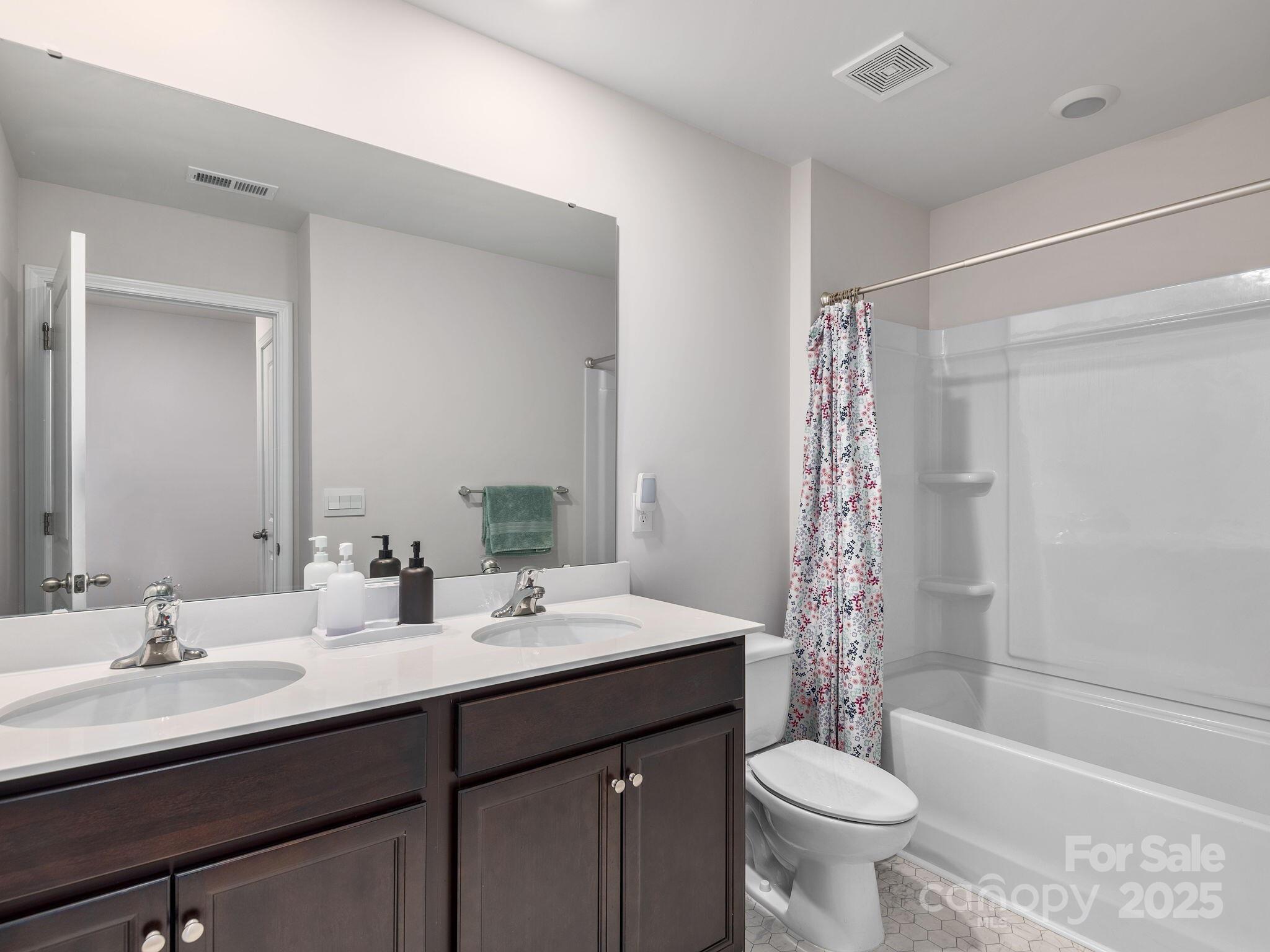 8 Madelyn Drive Clyde, NC 28721 - Photo 26 of 34 a bathroom with a double vanity sink toilet mirror and bathtub
