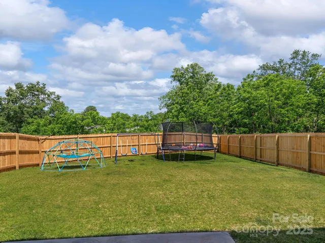 a view of a yard with large trees and a big yard