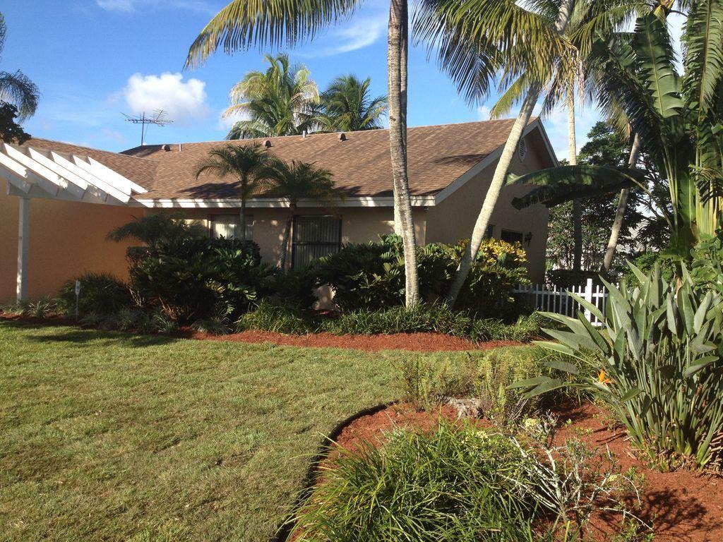9182 Gettysburg Road Boca Raton, FL 33434 - Photo 2 of 23 a view of swimming pool with a garden