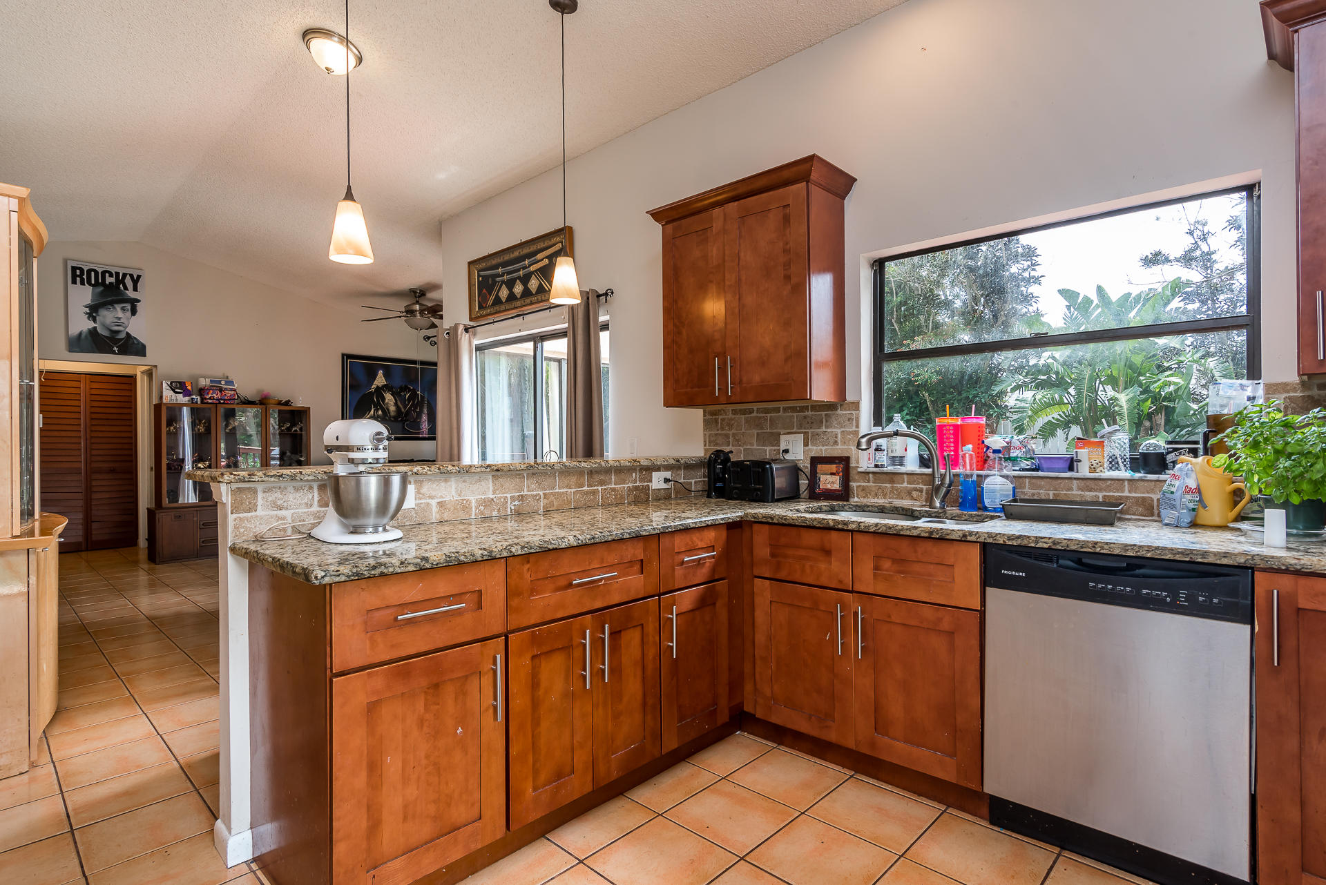 9182 Gettysburg Road Boca Raton, FL 33434 - Photo 4 of 23 a kitchen with stainless steel appliances granite countertop stove a microwave and a view of living room