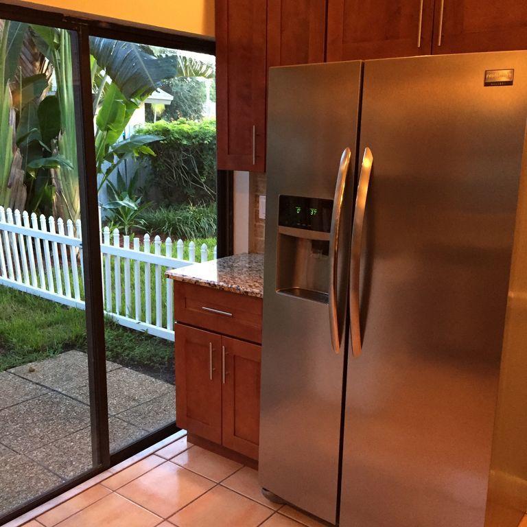 9182 Gettysburg Road Boca Raton, FL 33434 - Photo 6 of 23 a kitchen with stainless steel appliances granite countertop a refrigerator and a sink