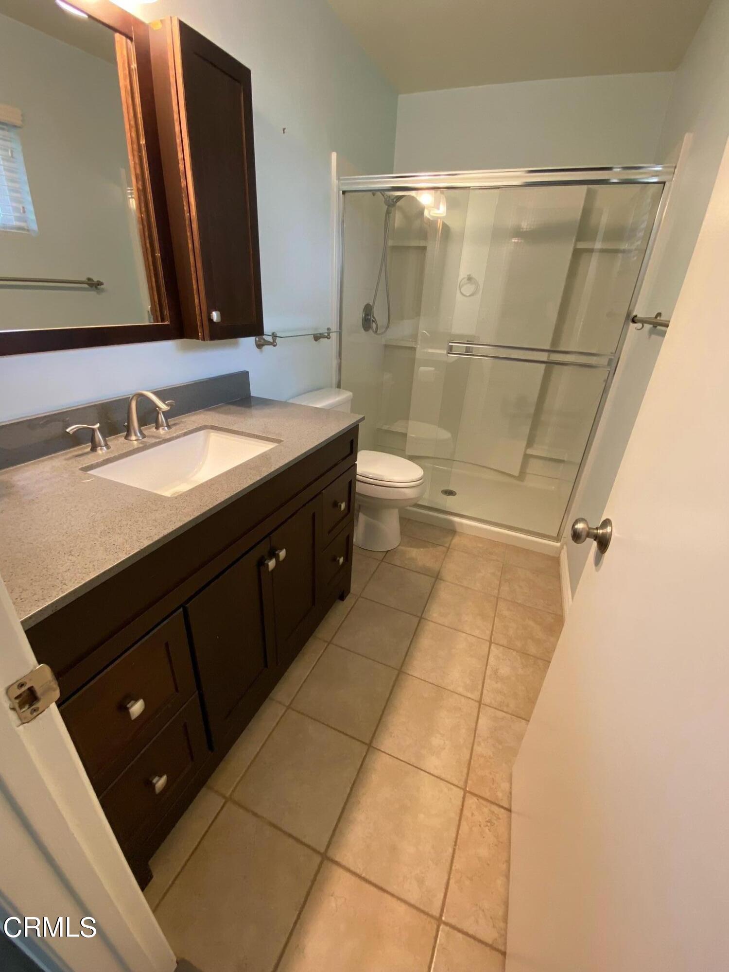 2046 Koala Way Ventura, CA 93003 - Photo 20 of 29 a bathroom with a double vanity sink toilet and shower