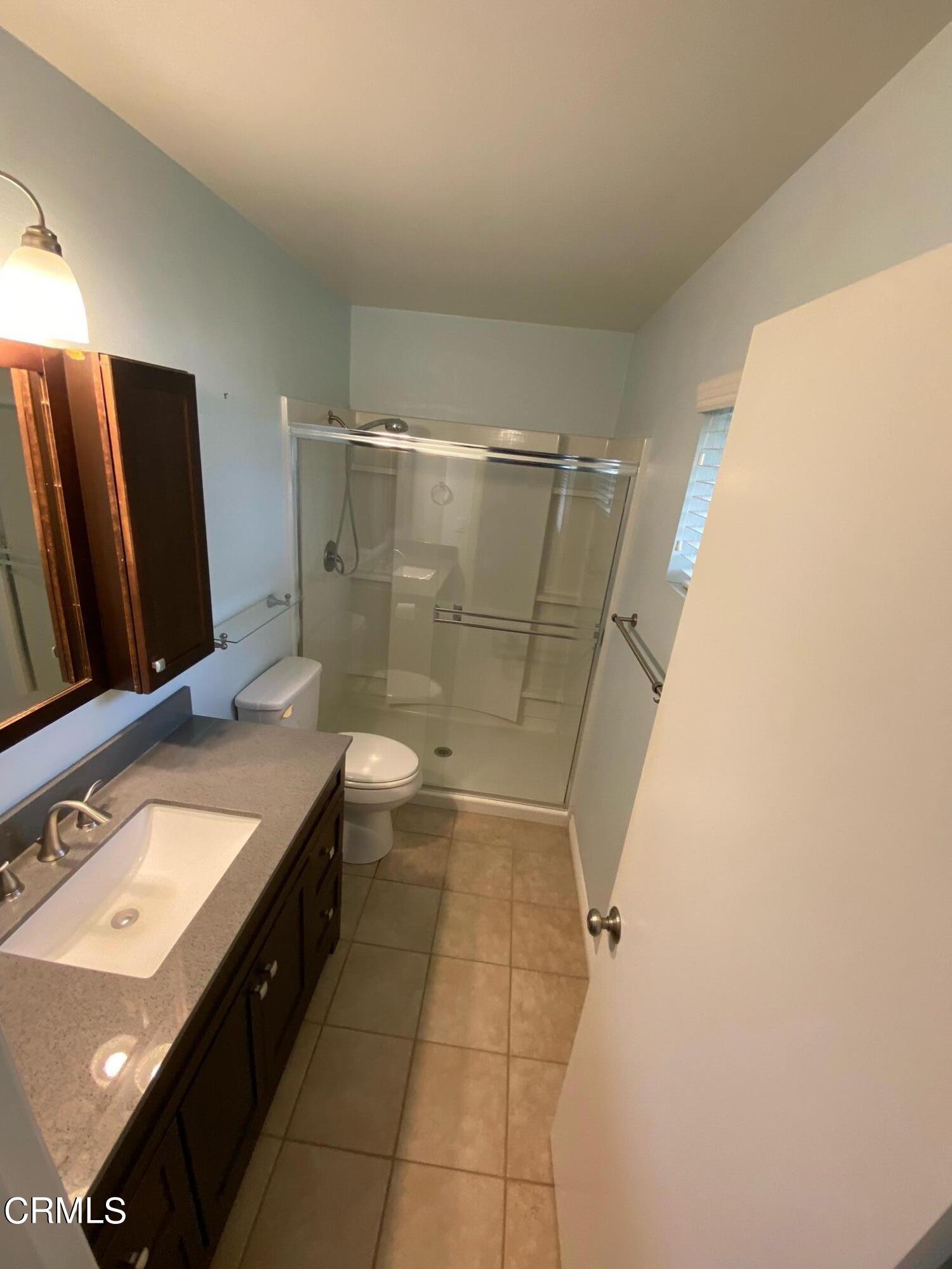 2046 Koala Way Ventura, CA 93003 - Photo 21 of 29 a bathroom with a double vanity sink toilet and shower