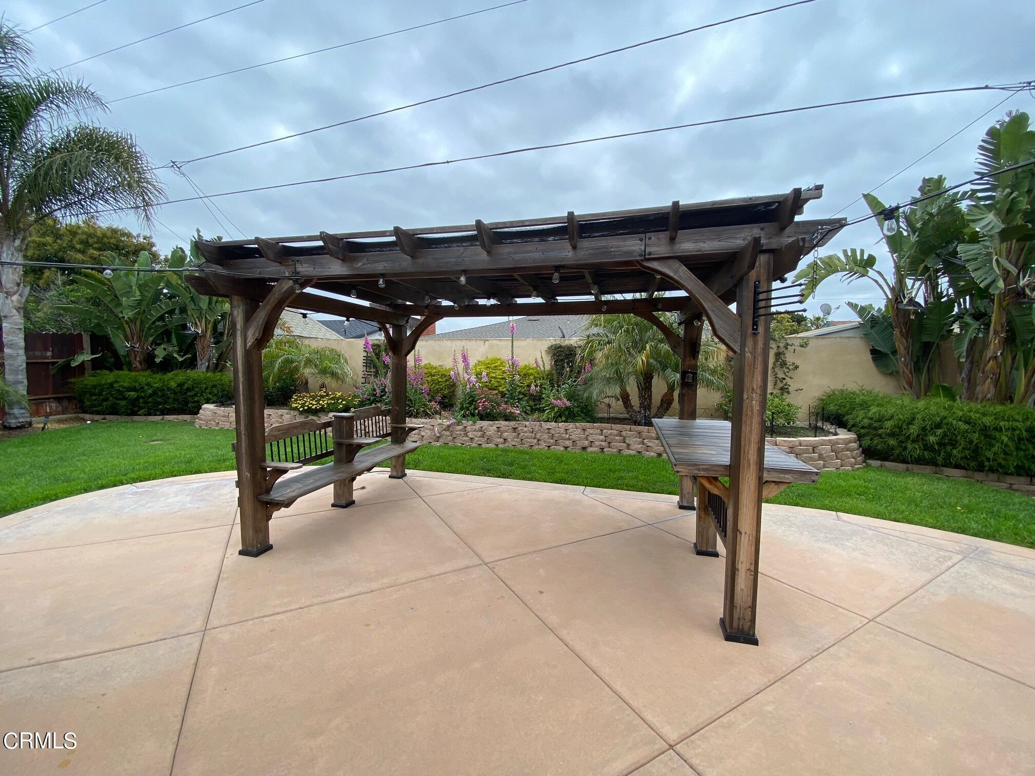 2046 Koala Way Ventura, CA 93003 - Photo 22 of 29 a view of a patio with a table and chairs under an umbrella