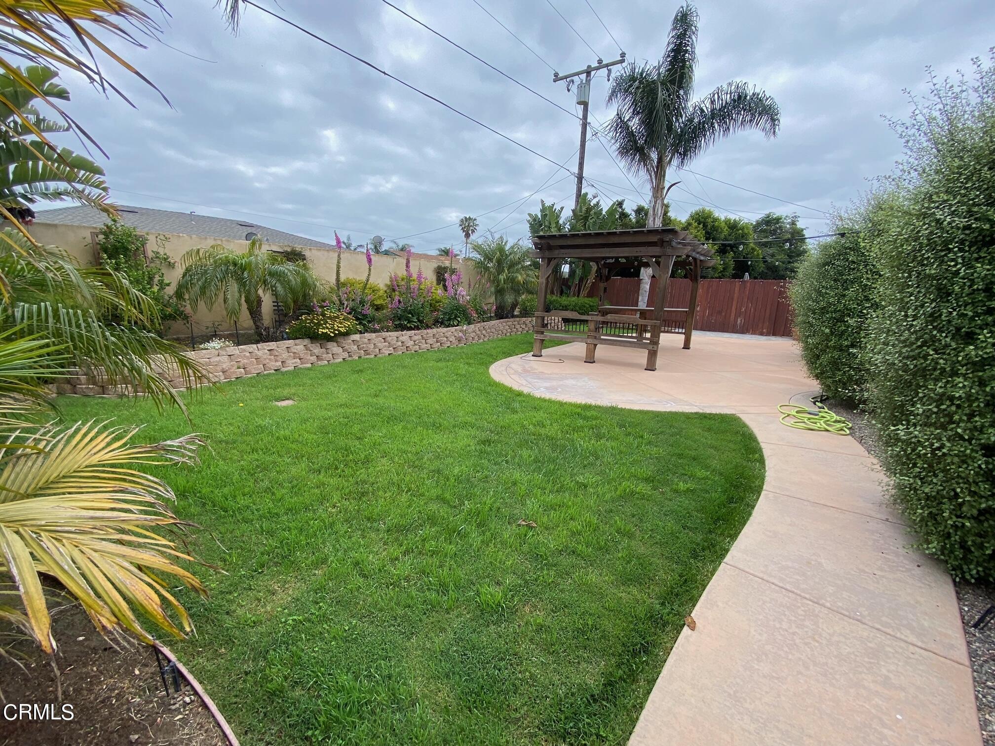 2046 Koala Way Ventura, CA 93003 - Photo 24 of 29 a swimming pool with outdoor seating and garden