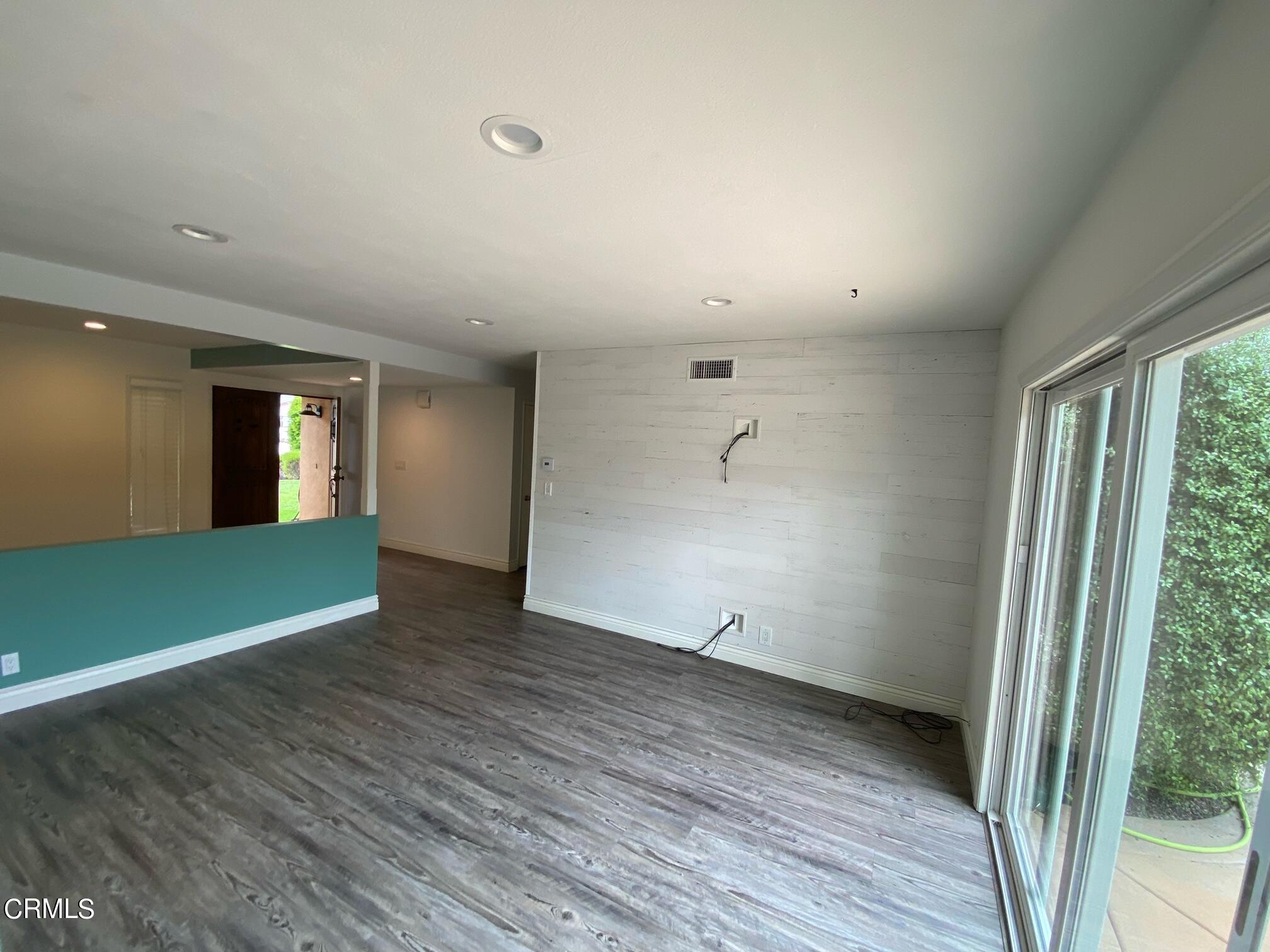 2046 Koala Way Ventura, CA 93003 - Photo 4 of 29 an empty room with wooden floor and windows